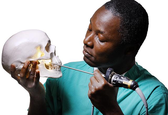 Dr. Boahene holding skull model
